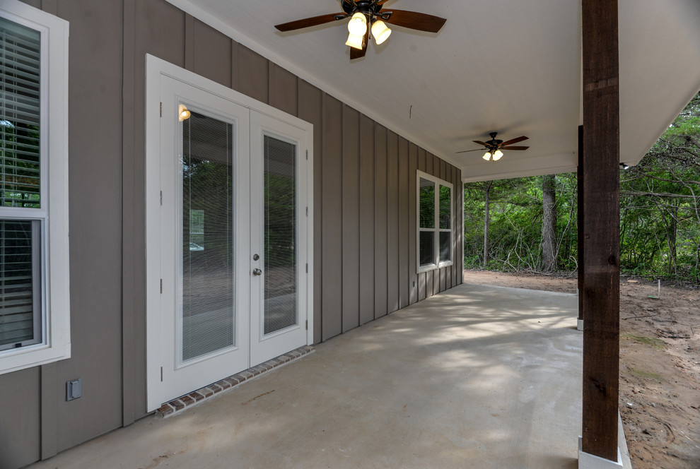 Mountain style concrete outdoor kitchen porch idea in Austin with a roof extension