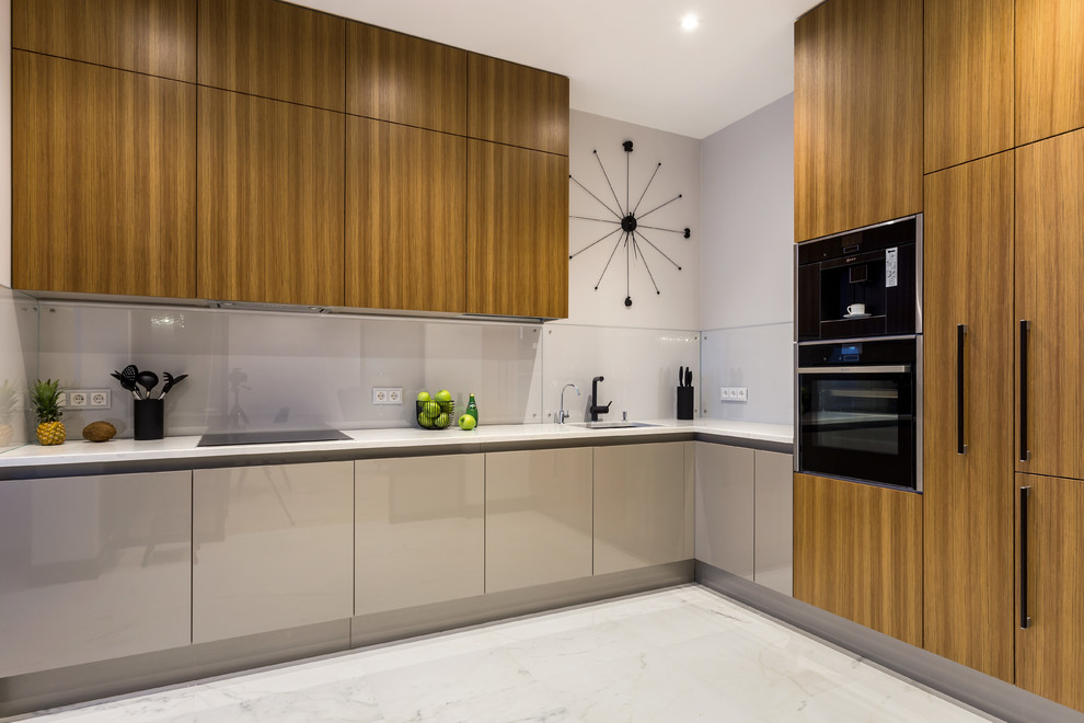 Inspiration for a mid-sized contemporary l-shaped kitchen in Saint Petersburg with an undermount sink, flat-panel cabinets, medium wood cabinets, quartz benchtops, glass sheet splashback, black appliances, porcelain floors, white floor, white benchtop, grey splashback and no island.