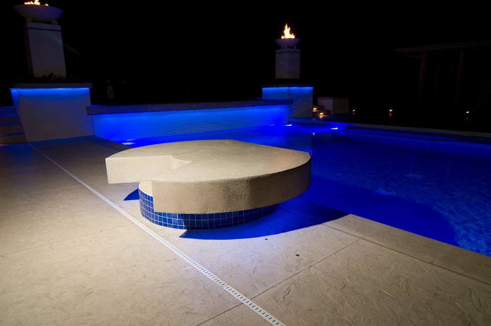 Inspiration for a large transitional backyard concrete paver and rectangular natural hot tub remodel in Cedar Rapids