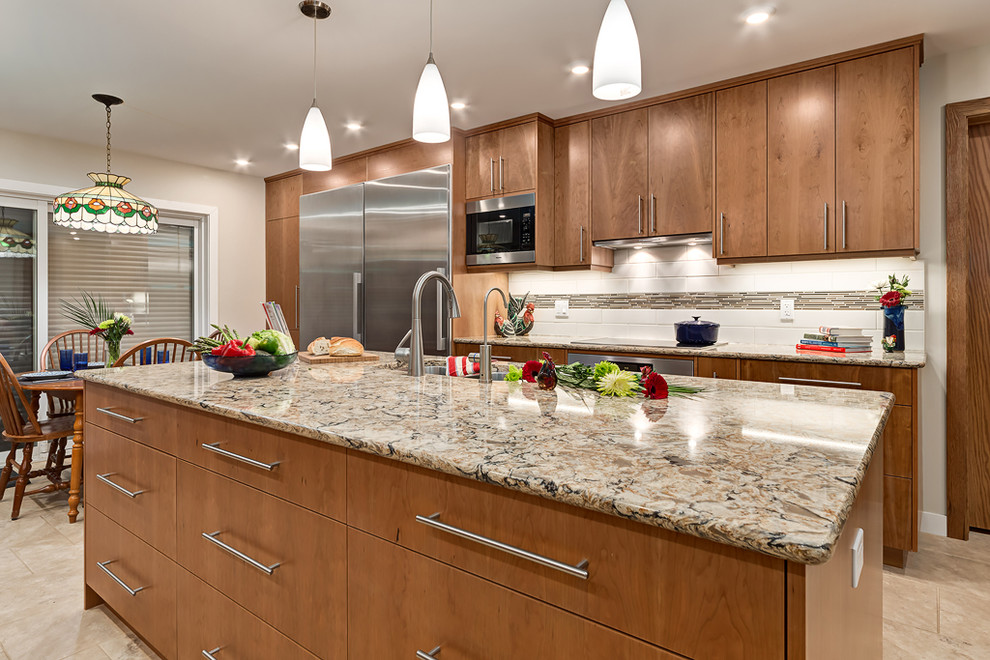 This is an example of a large scandinavian u-shaped eat-in kitchen in Calgary with an undermount sink, flat-panel cabinets, medium wood cabinets, granite benchtops, white splashback, glass tile splashback, stainless steel appliances, porcelain floors and with island.