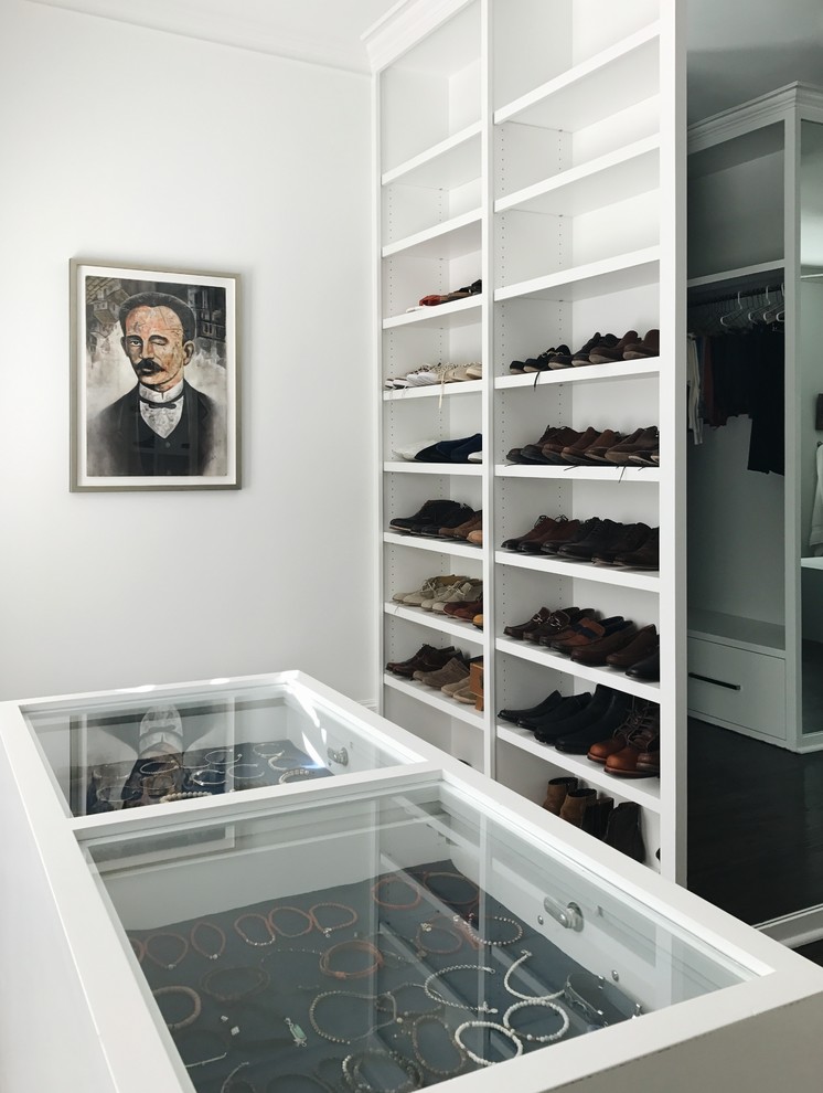 Example of a trendy gender-neutral walk-in closet design with open cabinets and white cabinets