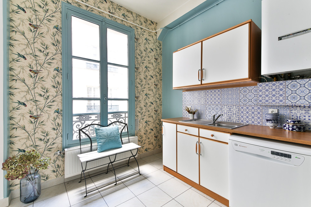 Photo of a mid-sized traditional l-shaped separate kitchen in Marseille with a drop-in sink, white cabinets, wood benchtops, blue splashback, cement tile splashback, white appliances and no island.