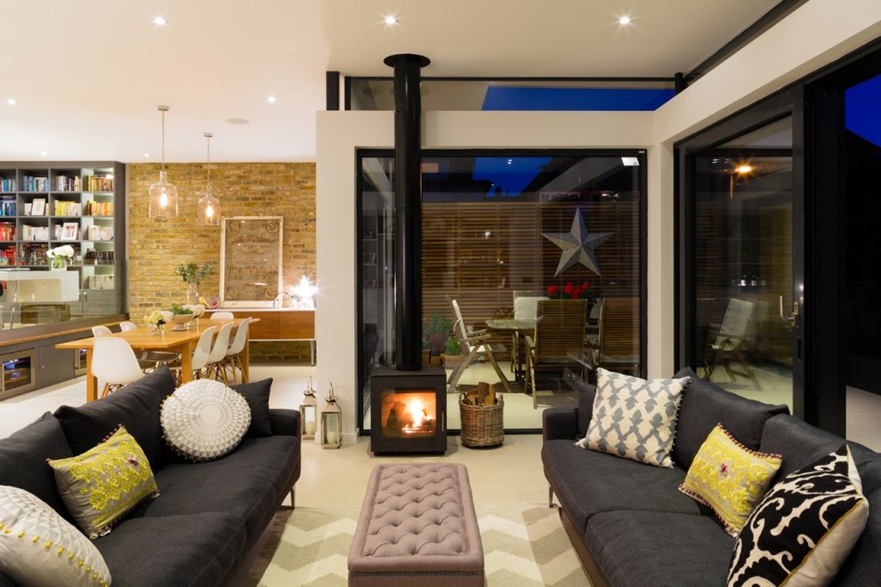 Inspiration for a contemporary open concept living room in London with a wood stove.