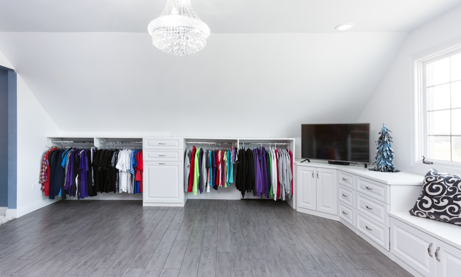 Design ideas for an expansive traditional gender-neutral dressing room in Chicago with raised-panel cabinets, white cabinets and ceramic floors.