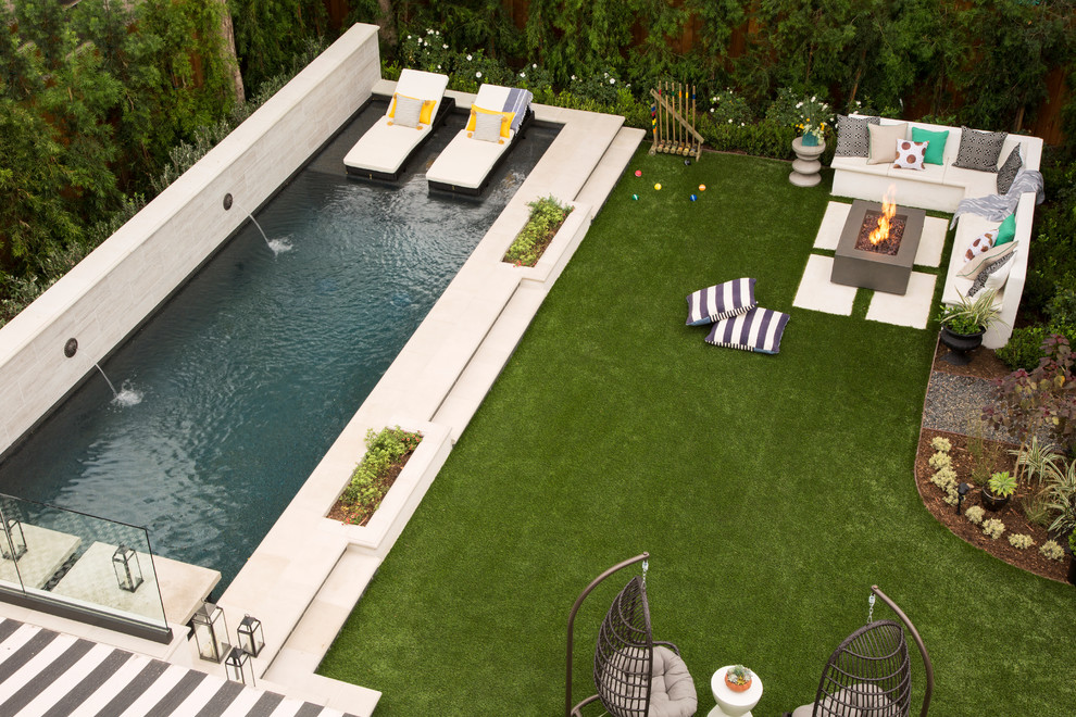 Large transitional backyard rectangular lap pool in Los Angeles with concrete pavers.