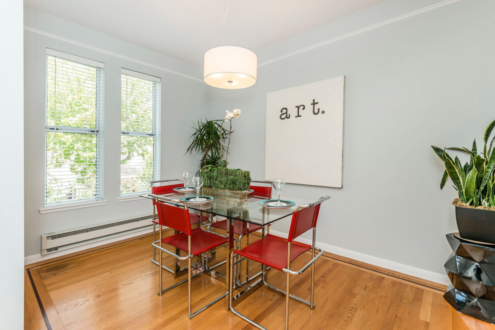 This is an example of a small eclectic open plan dining in San Francisco with grey walls, light hardwood floors, no fireplace and beige floor.