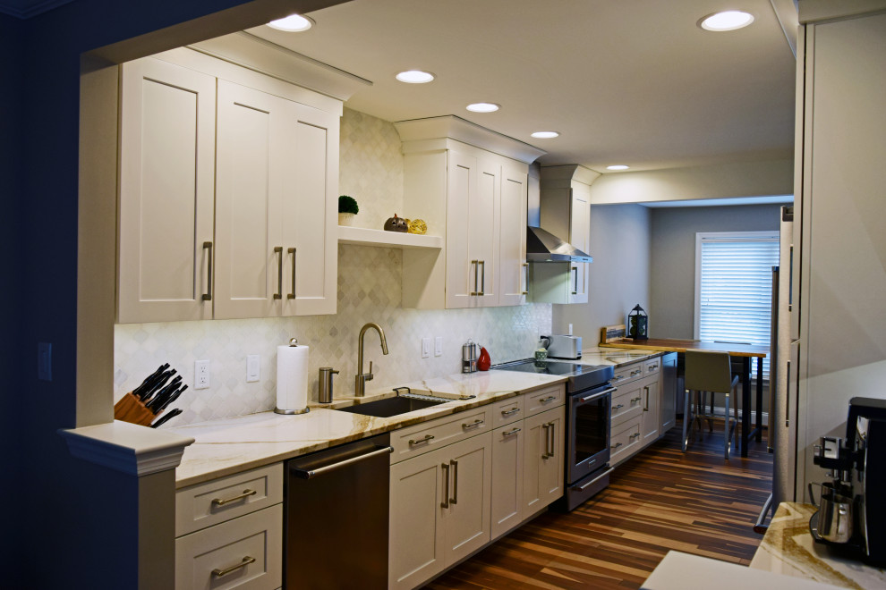 Kitchen - transitional medium tone wood floor kitchen idea with an undermount sink, shaker cabinets, white cabinets, quartz countertops, white backsplash, marble backsplash, stainless steel appliances, no island and white countertops