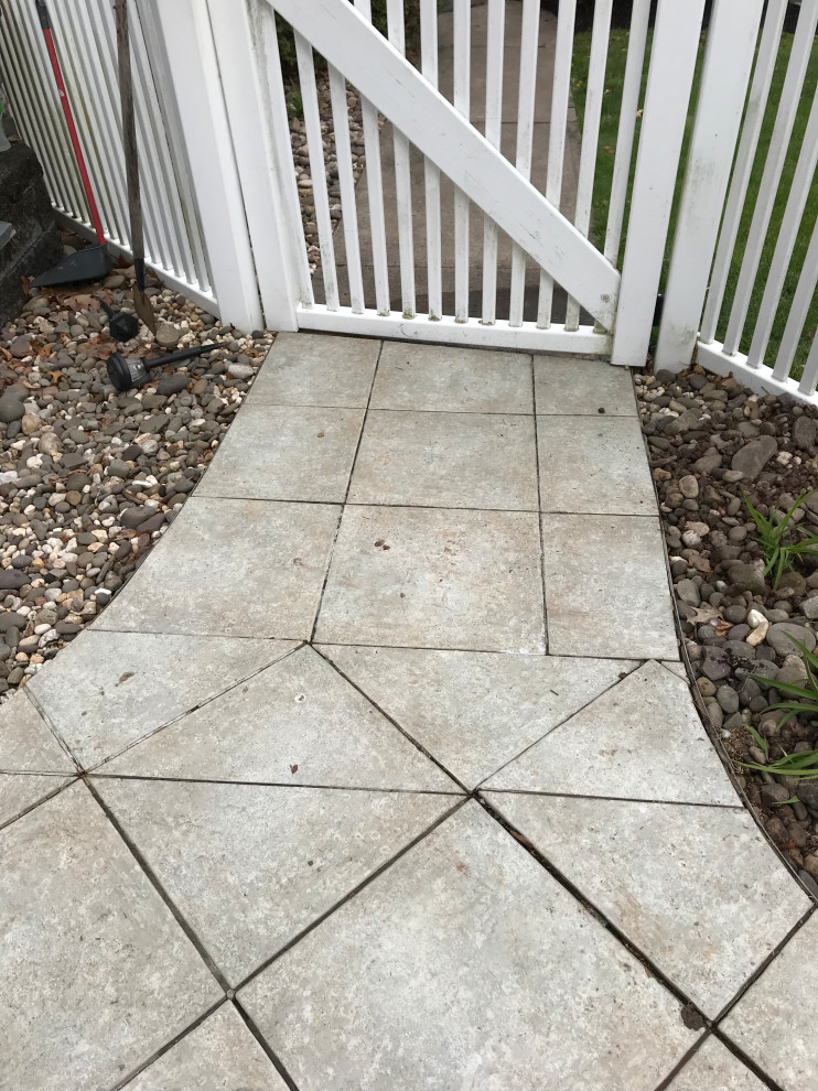 Example of a mid-sized transitional concrete paver pool design
