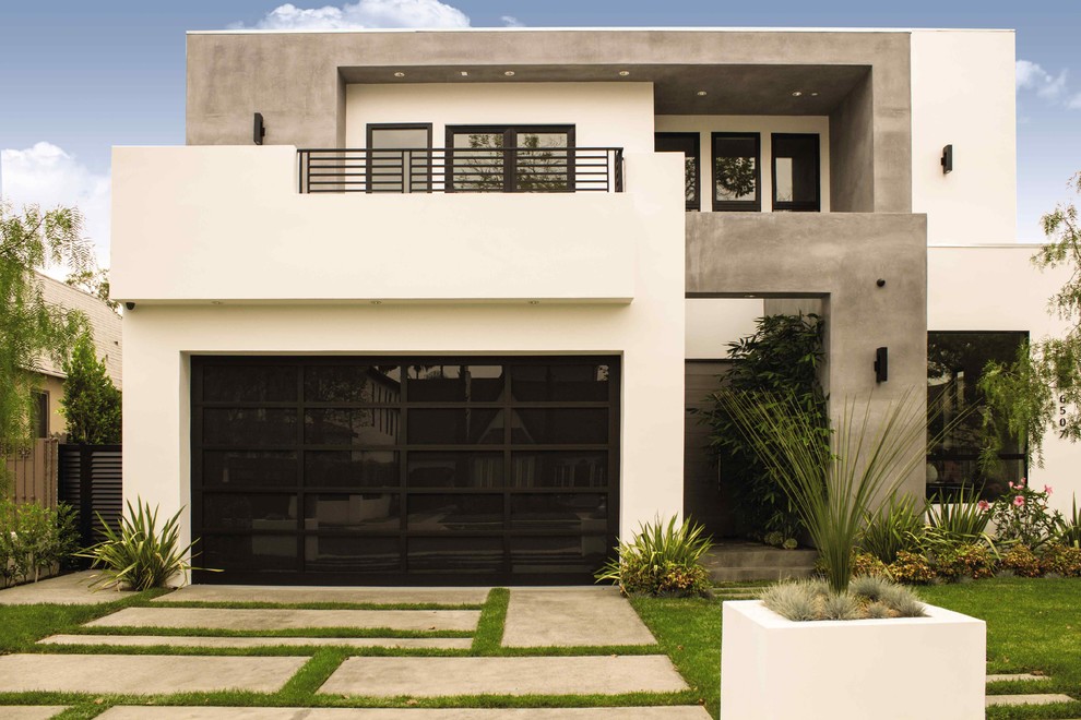 Garage - modern attached two-car garage idea in Dallas