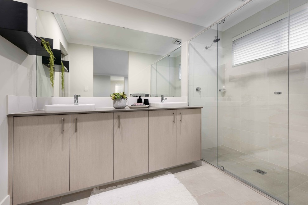 Photo of a mid-sized contemporary master bathroom in Perth with flat-panel cabinets, light wood cabinets, a double shower, white tile, ceramic tile, grey walls, ceramic floors, an integrated sink, engineered quartz benchtops, grey floor and a hinged shower door.