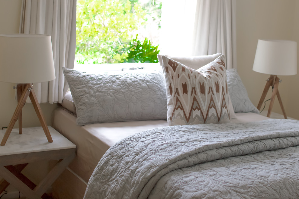 Photo of a mid-sized country guest bedroom in Adelaide with white walls, carpet and beige floor.
