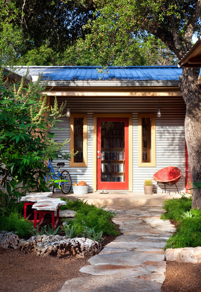 Inspiration for an eclectic entryway in Austin with a single front door and a red front door.