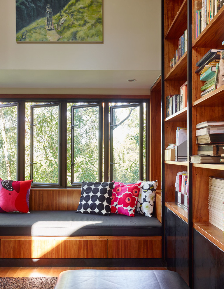Mid-sized contemporary open concept family room in Brisbane with a library.