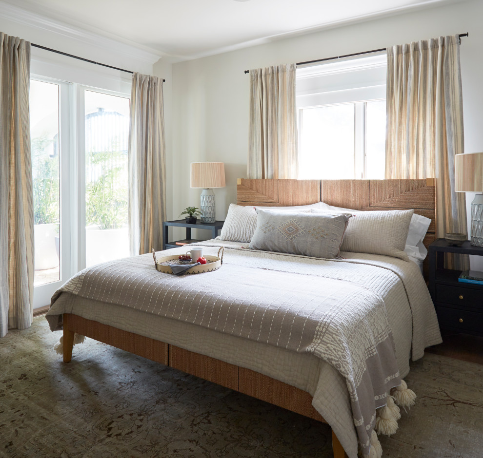 This is an example of a world-inspired master bedroom in Miami with beige walls.