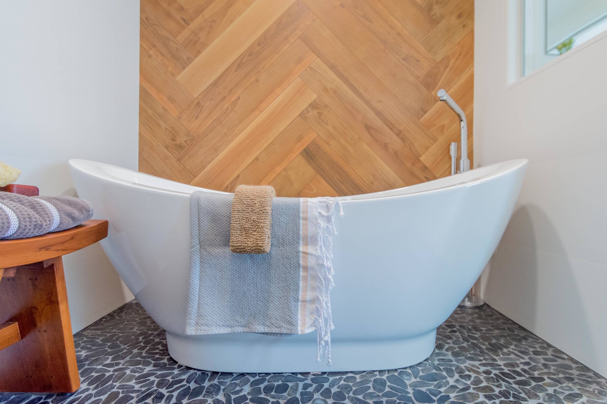 Mid-sized trendy master brown tile and porcelain tile bathroom photo in Portland Maine with flat-panel cabinets, white cabinets, white walls, an undermount sink, granite countertops, a hinged shower d