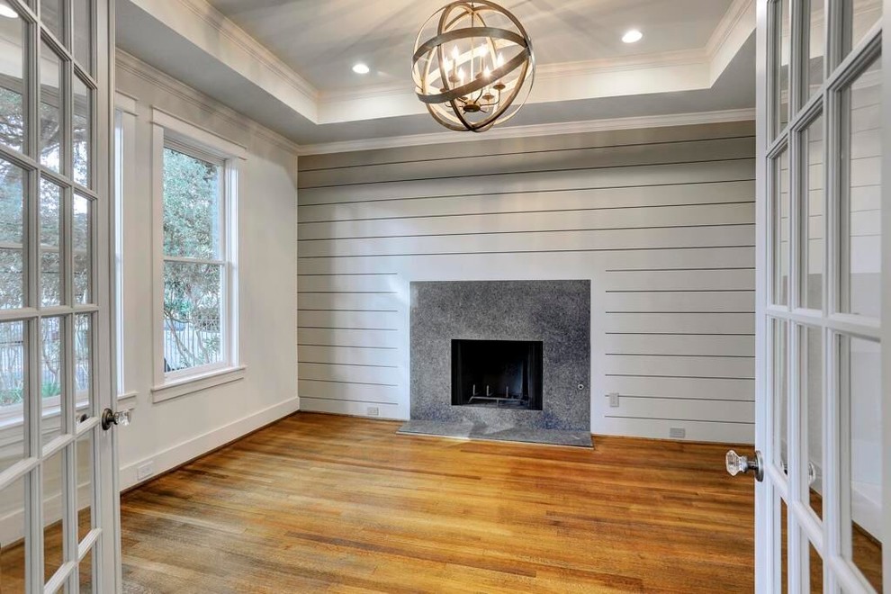 Design ideas for a mid-sized study room in Houston with white walls, dark hardwood floors, a standard fireplace and a stone fireplace surround.