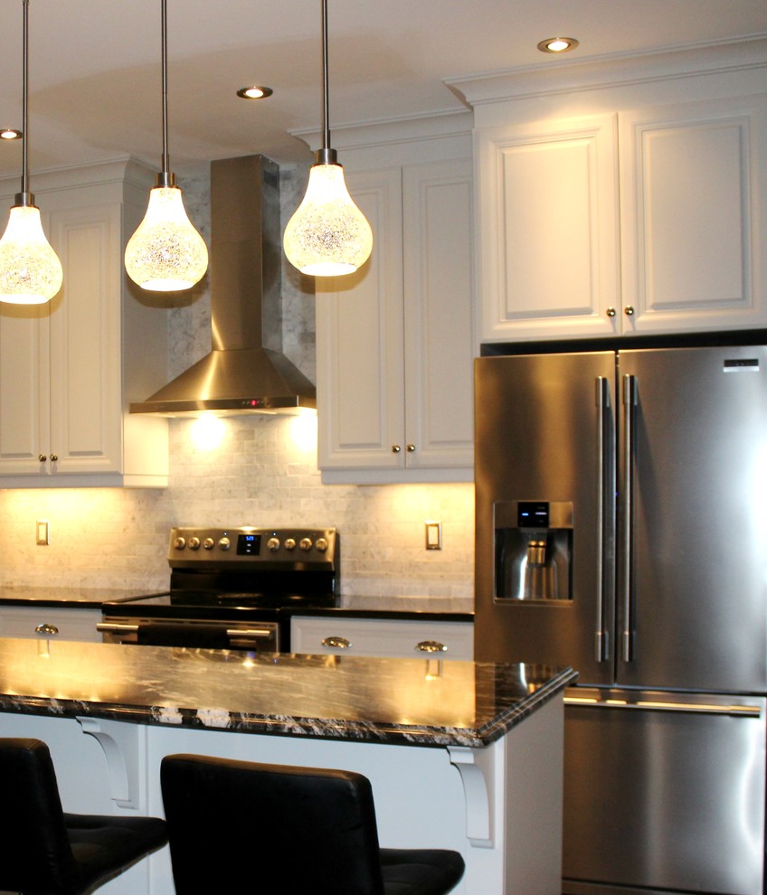 Example of a mid-sized transitional l-shaped dark wood floor open concept kitchen design in Toronto with an undermount sink, raised-panel cabinets, white cabinets, quartzite countertops, gray backsplash, subway tile backsplash, stainless steel appliances and an island