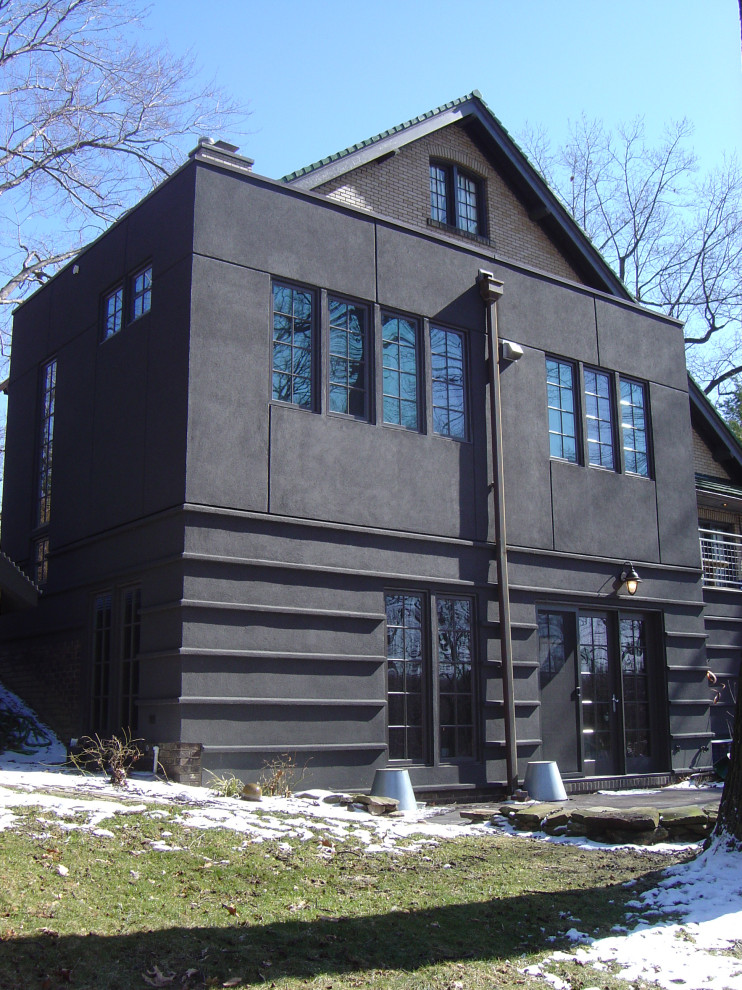 Inspiration for a mid-sized modern multicolored two-story stucco exterior home remodel in Cleveland with a mixed material roof