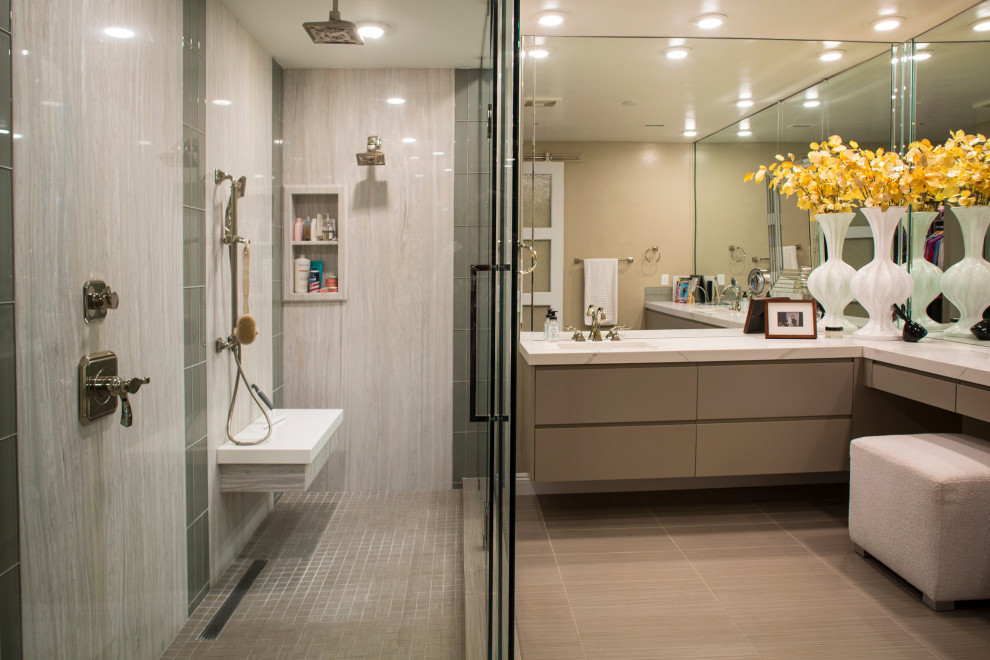 Expansive contemporary ensuite bathroom in Las Vegas with flat-panel cabinets, green cabinets, a double shower, a bidet, green tiles, stone slabs, beige walls, porcelain flooring, a built-in sink, engineered stone worktops, beige floors, a hinged door, white worktops, a shower bench, double sinks and a floating vanity unit.