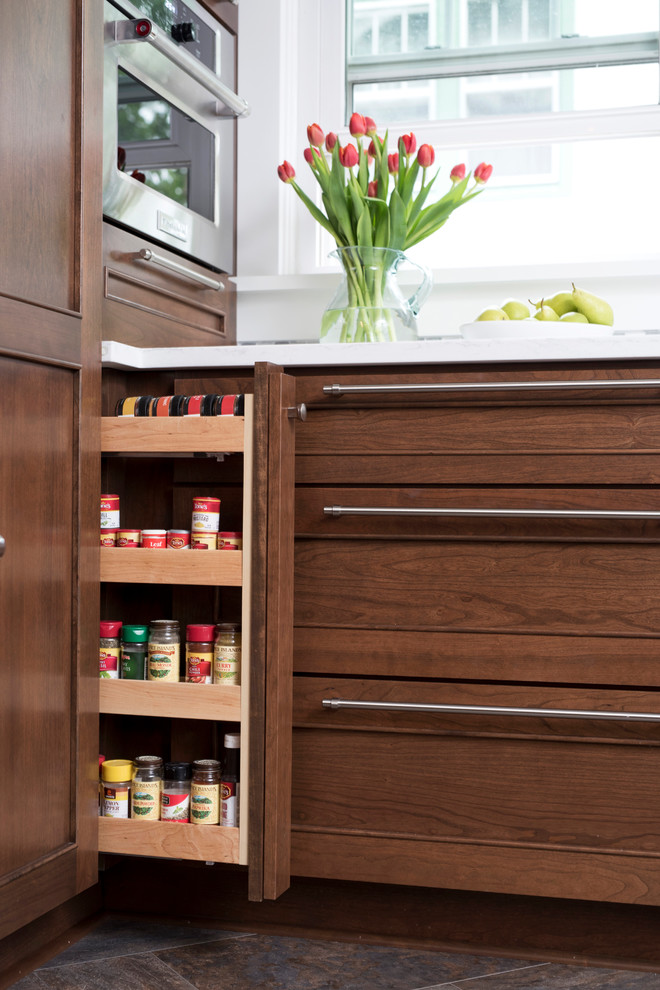 Inspiration for a mid-sized transitional u-shaped vinyl floor and multicolored floor kitchen remodel with an undermount sink, shaker cabinets, brown cabinets, quartz countertops, gray backsplash, marble backsplash, stainless steel appliances, no island and white countertops