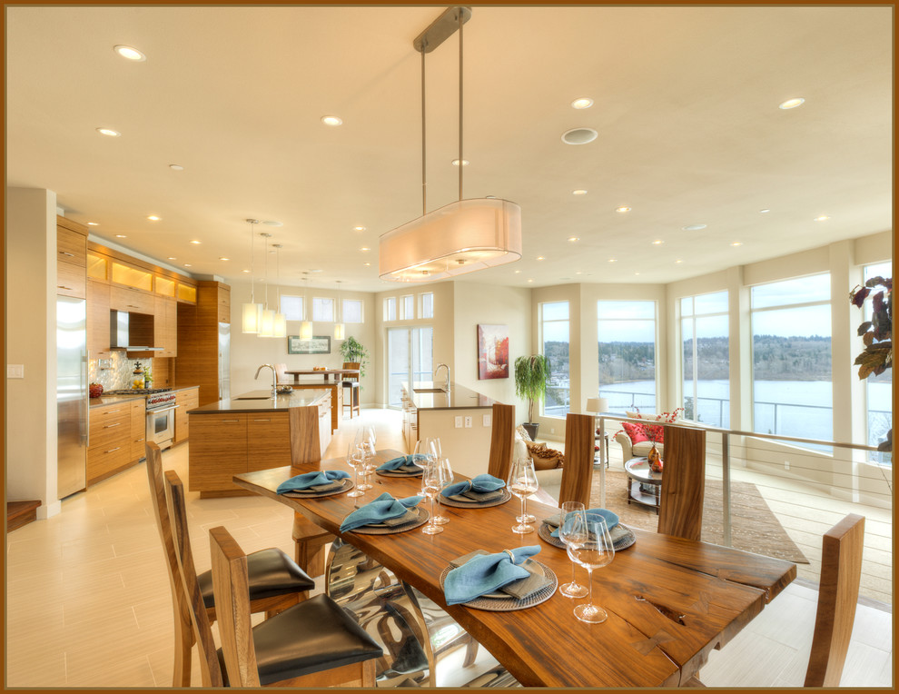 Photo of a large contemporary kitchen/dining combo in Seattle with beige walls, porcelain floors and beige floor.