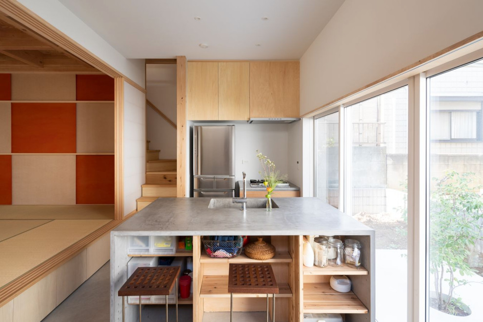 Photo of a small asian galley eat-in kitchen in Other with an integrated sink, open cabinets, light wood cabinets, brown splashback, timber splashback, stainless steel appliances, concrete floors, a peninsula, grey floor, grey benchtop and timber.