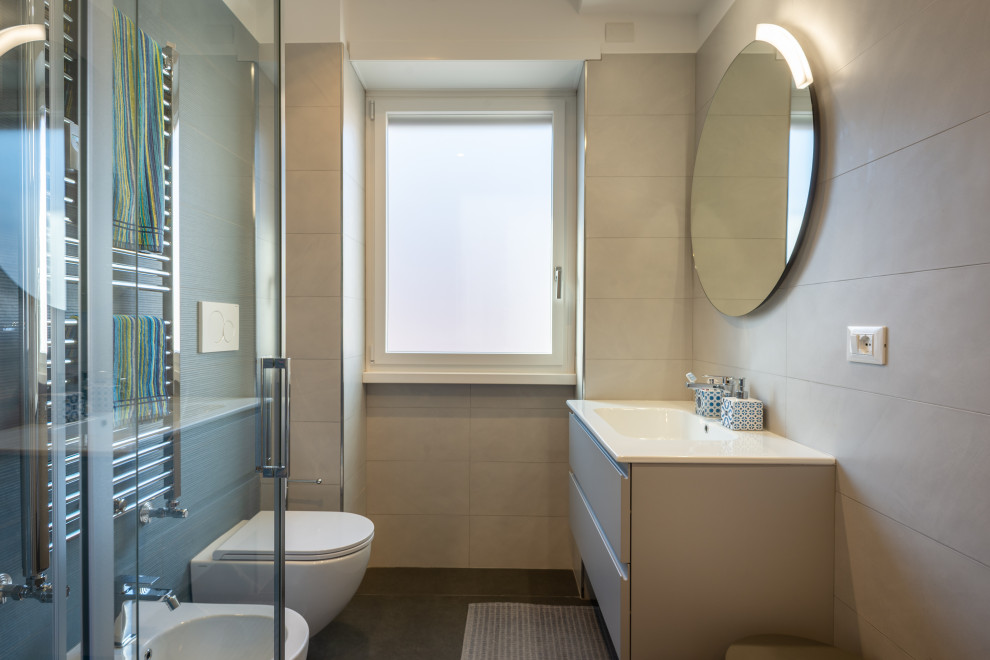 Inspiration for a small modern cloakroom in Rome with flat-panel cabinets, beige cabinets, a two-piece toilet, blue tiles, porcelain tiles, white walls, porcelain flooring, an integrated sink, grey floors, white worktops and a floating vanity unit.