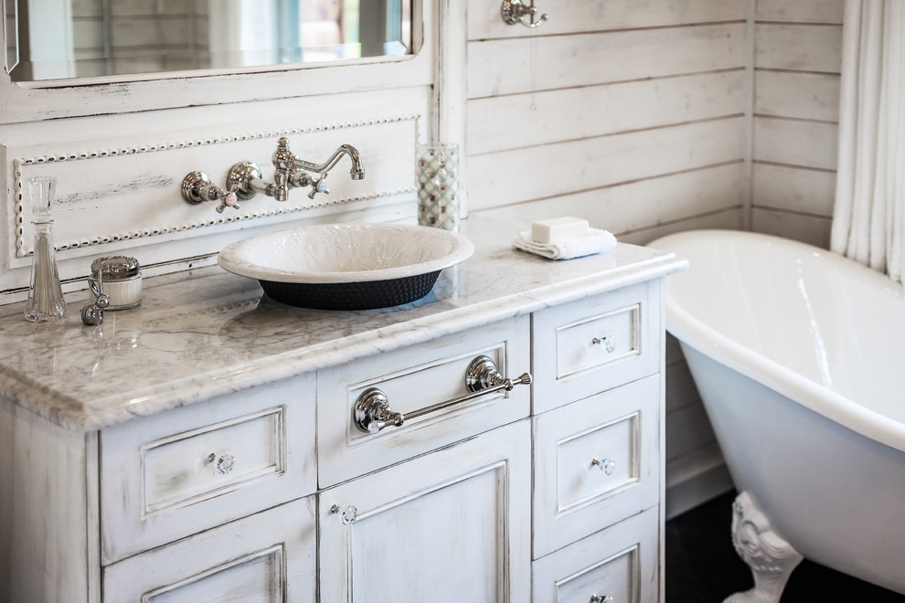 Small traditional master bathroom in Charlotte with flat-panel cabinets, white cabinets, a freestanding tub, a two-piece toilet, black tile, porcelain tile, white walls, porcelain floors, a vessel sink and marble benchtops.