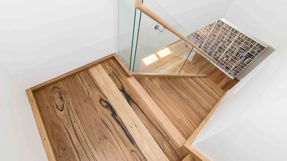 Inspiration for a contemporary wood straight staircase in Melbourne with mixed railing.
