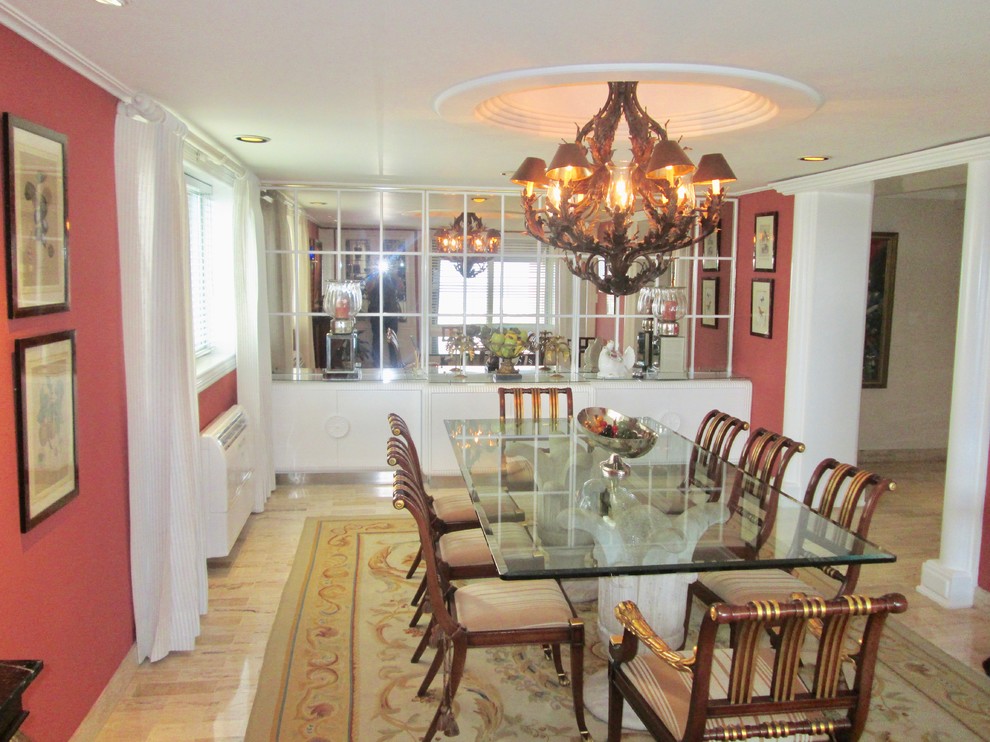 This is an example of a traditional dining room in Other with red walls, marble floors and beige floor.