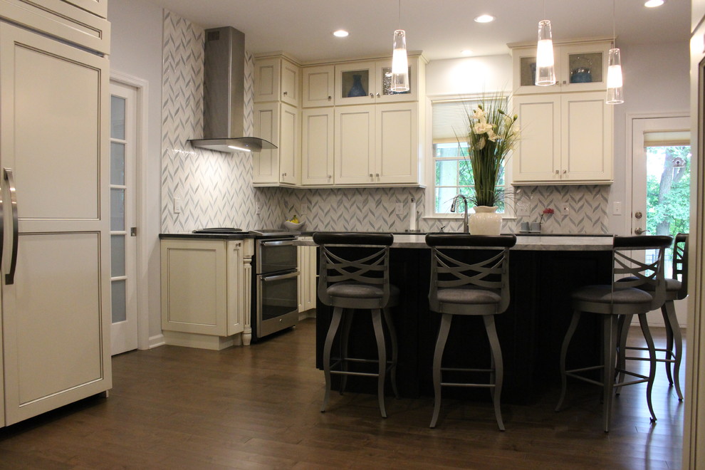 Inspiration for a mid-sized transitional l-shaped dark wood floor and brown floor eat-in kitchen remodel in New York with a farmhouse sink, recessed-panel cabinets, white cabinets, solid surface countertops, white backsplash, cement tile backsplash, stainless steel appliances and an island