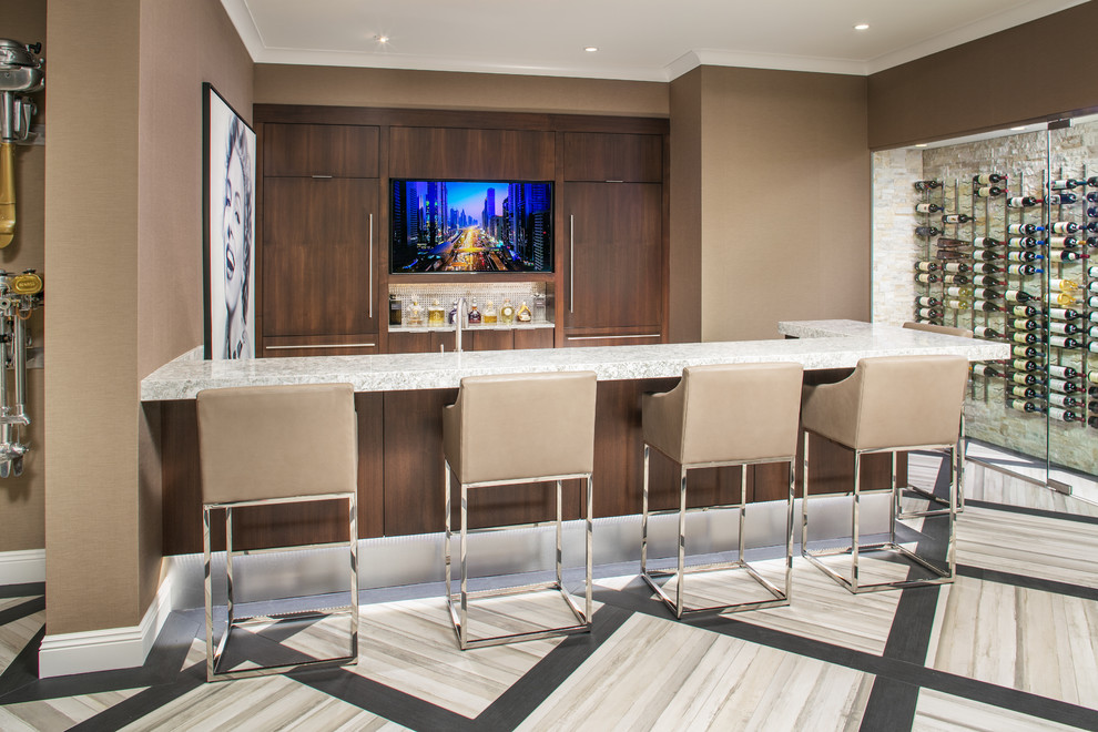 Large contemporary u-shaped seated home bar in Omaha with flat-panel cabinets, an undermount sink, dark wood cabinets, quartzite benchtops, beige splashback, glass tile splashback, porcelain floors and beige floor.