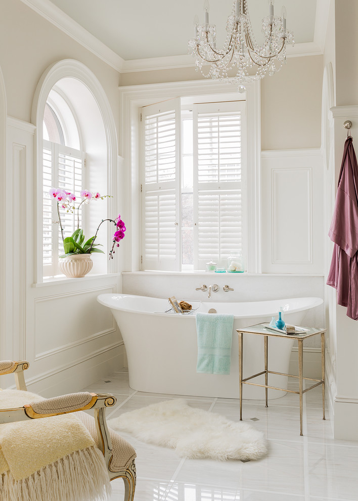 Photo of a traditional master bathroom in Boston with a freestanding tub and beige walls.