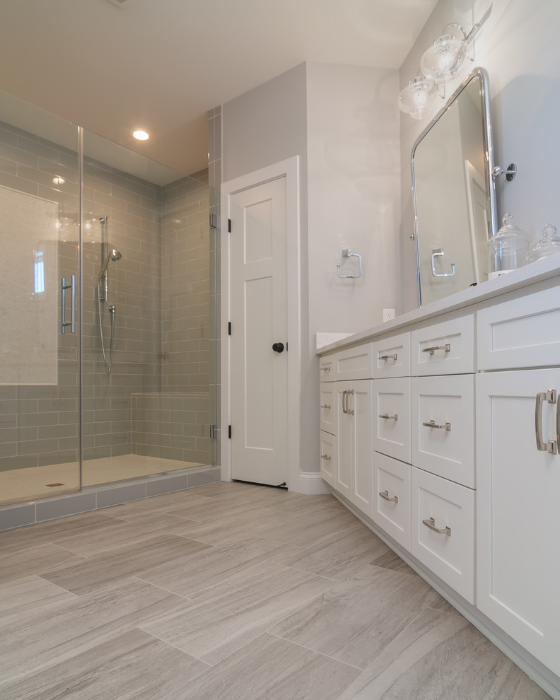 Large traditional master bathroom in Other with recessed-panel cabinets, white cabinets, a corner shower, grey walls, vinyl floors, granite benchtops, beige floor and a hinged shower door.