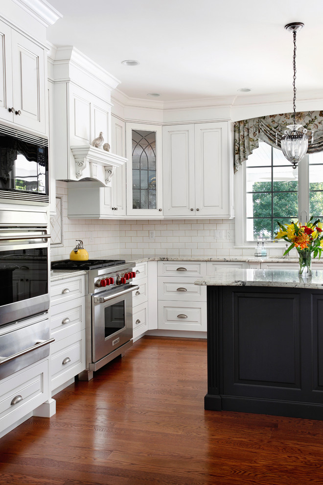 Eat-in kitchen - traditional l-shaped eat-in kitchen idea in Philadelphia with an undermount sink, raised-panel cabinets, white cabinets, granite countertops, white backsplash, subway tile backsplash and stainless steel appliances