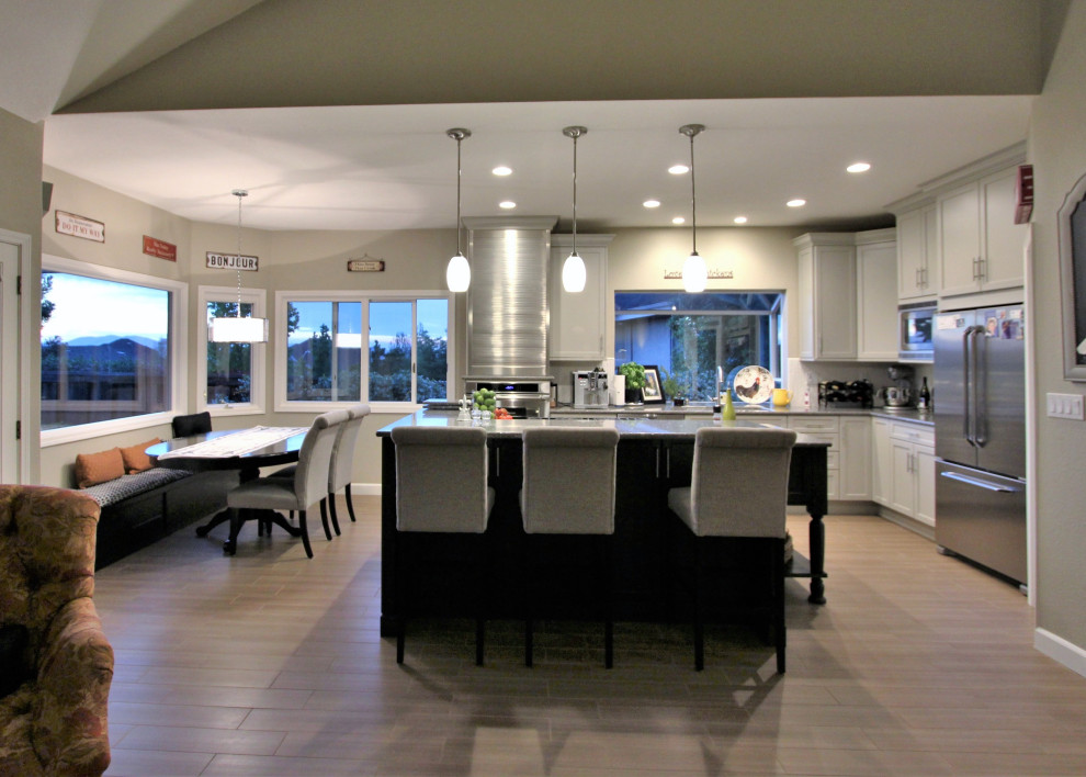 Inspiration for a large transitional l-shaped porcelain tile and beige floor open concept kitchen remodel in San Francisco with an undermount sink, recessed-panel cabinets, beige cabinets, quartz countertops, white backsplash, subway tile backsplash, stainless steel appliances, an island and gray countertops