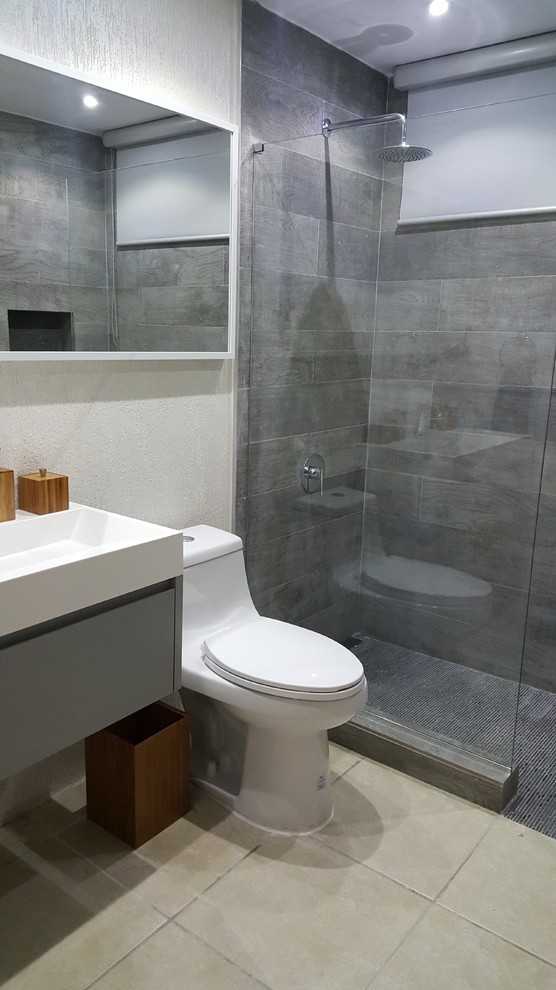 This is an example of a small modern bathroom in Other with grey cabinets, an open shower, a one-piece toilet, gray tile, porcelain tile, white walls, ceramic floors, an integrated sink and quartzite benchtops.