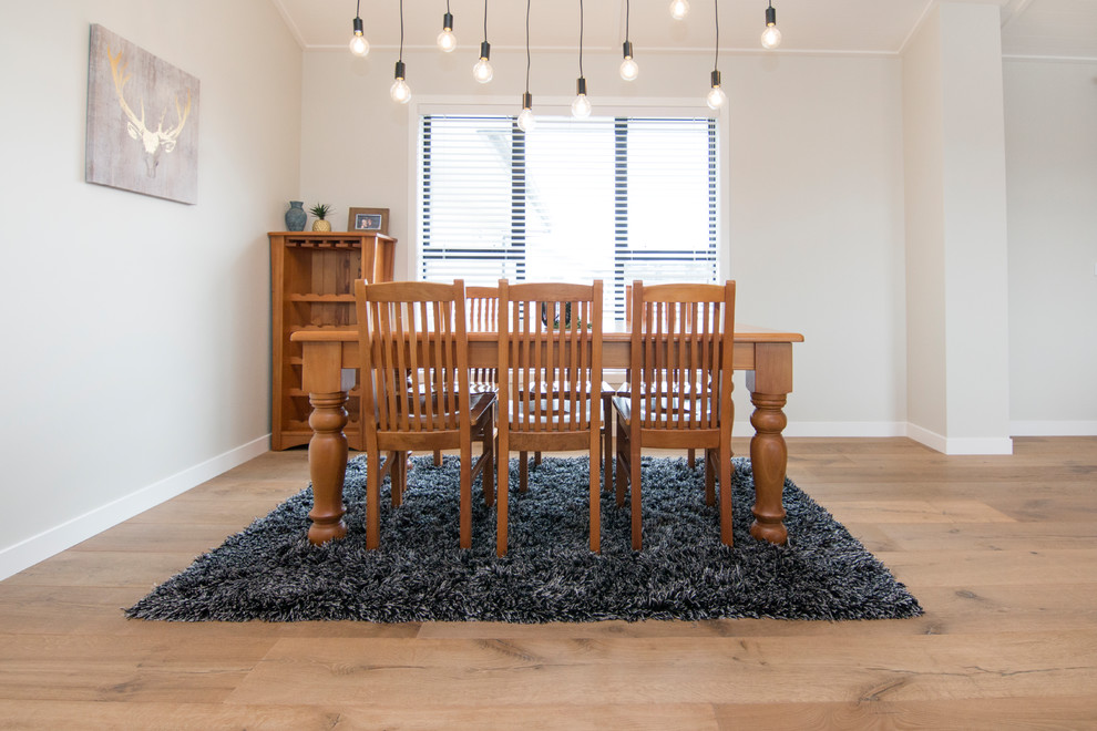Mid-sized country kitchen/dining combo in Auckland With Medium Hardwood Floors, Beige Floor, Beige Walls and No Fireplace.
