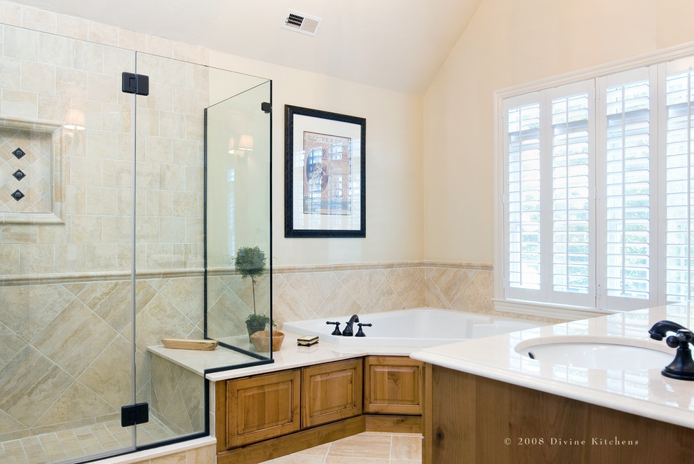 Design ideas for a large traditional master bathroom in Boston with beaded inset cabinets, medium wood cabinets, a drop-in tub, beige tile, a trough sink, a corner shower and beige walls.