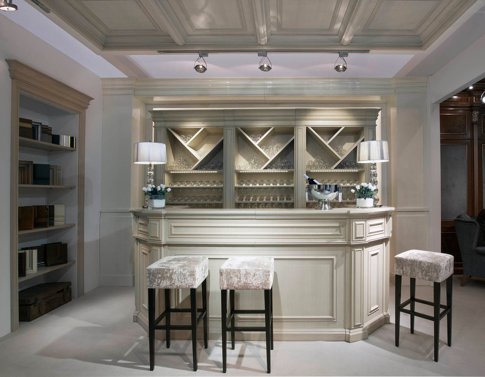 Photo of a mid-sized traditional single-wall seated home bar in Valencia with open cabinets and beige cabinets.