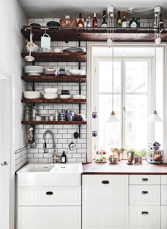 Industrial kitchen pantry in Stockholm with a double-bowl sink, open cabinets, dark wood cabinets, wood benchtops, white splashback and porcelain splashback.