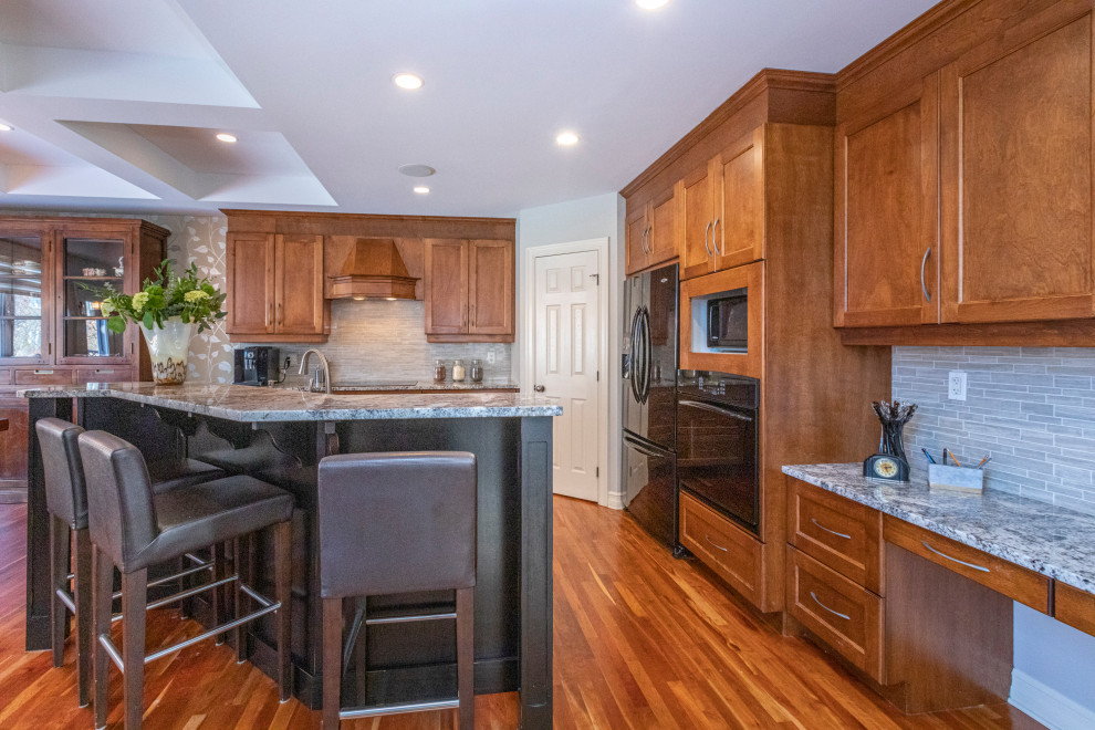 Example of a large transitional medium tone wood floor kitchen design in Ottawa with shaker cabinets, medium tone wood cabinets, granite countertops, gray backsplash, mosaic tile backsplash, stainless steel appliances and an island