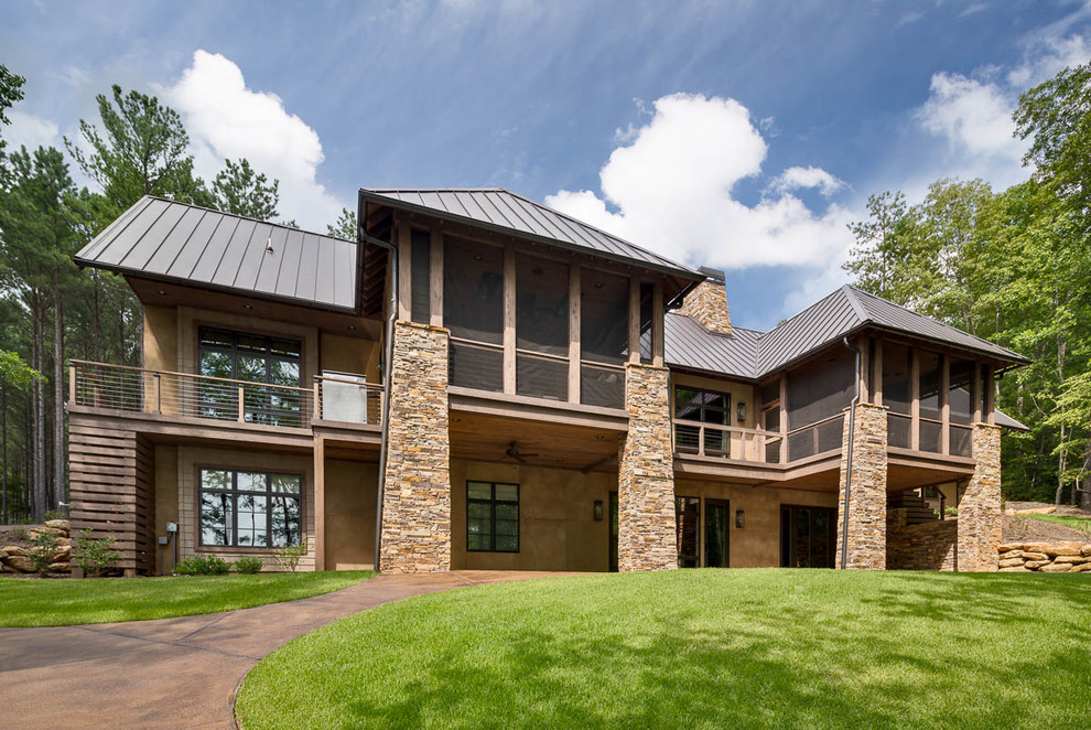 Large rustic beige two-story stucco gable roof idea