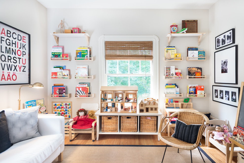 Inspiration for a country kids' playroom for kids 4-10 years old and girls in Boston with medium hardwood floors and white walls.