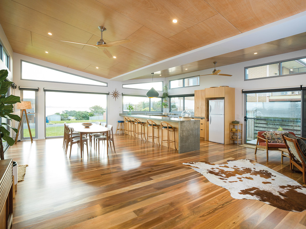 Inspiration for a contemporary u-shaped open plan kitchen in Melbourne with flat-panel cabinets, medium wood cabinets, medium hardwood floors, a peninsula and brown floor.