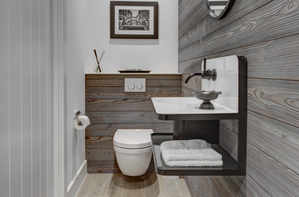 This is an example of a large modern ensuite bathroom in Gloucestershire with flat-panel cabinets, white cabinets, a freestanding bath, a walk-in shower, a wall mounted toilet, porcelain tiles, porcelain flooring, a wall-mounted sink, an open shower, a single sink and a floating vanity unit.