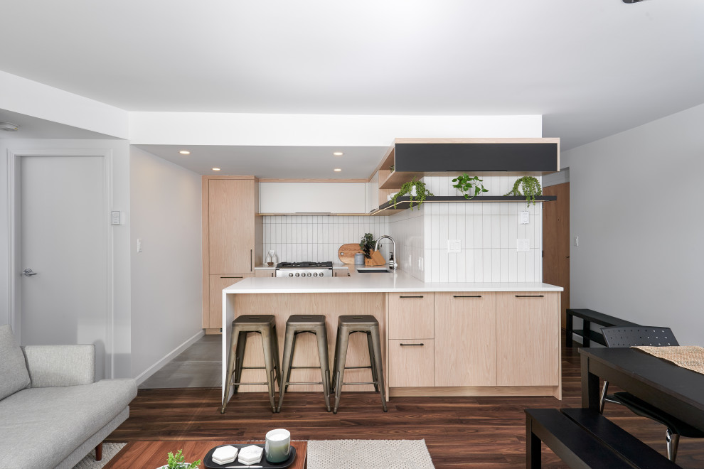 Inspiration for a small contemporary u-shaped eat-in kitchen in Vancouver with flat-panel cabinets, light wood cabinets, quartz benchtops and a peninsula.