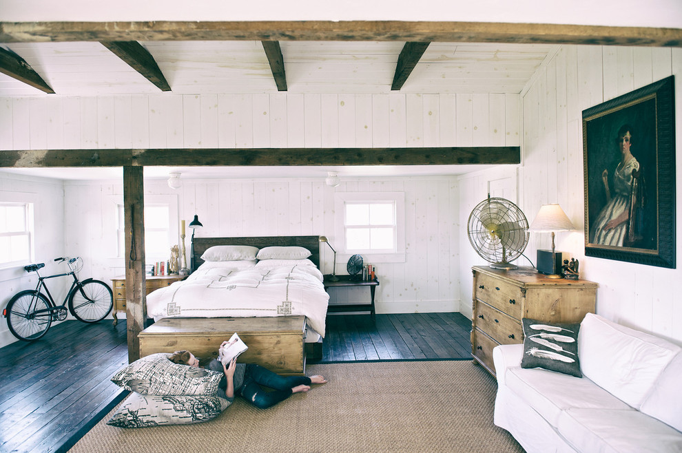 Photo of a country bedroom in San Francisco with black floor.