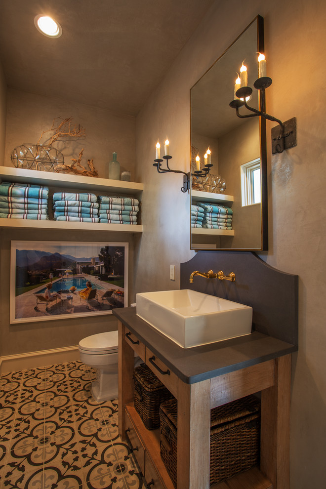 This is an example of a mid-sized beach style powder room in Houston with beige walls, a vessel sink and multi-coloured floor.