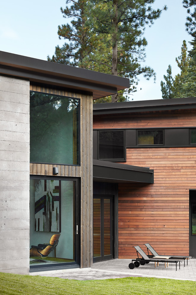 Inspiration for a huge modern backyard concrete patio remodel in San Francisco with a roof extension